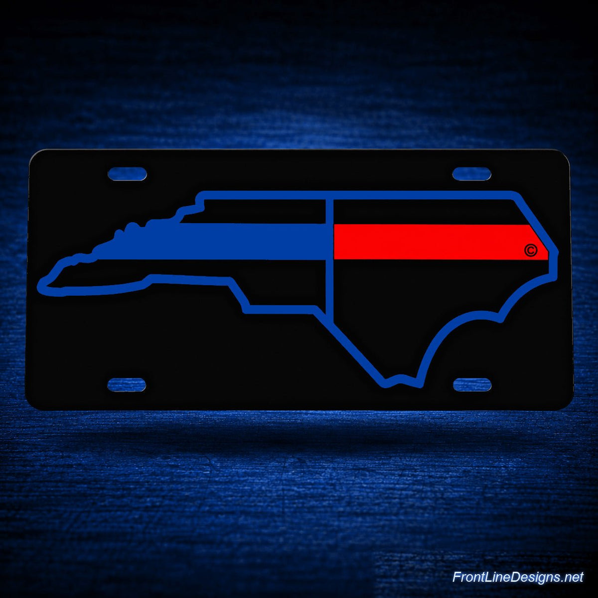North Carolina Public Safety Reflective License Plate — floating presentation on blue textured backdrop