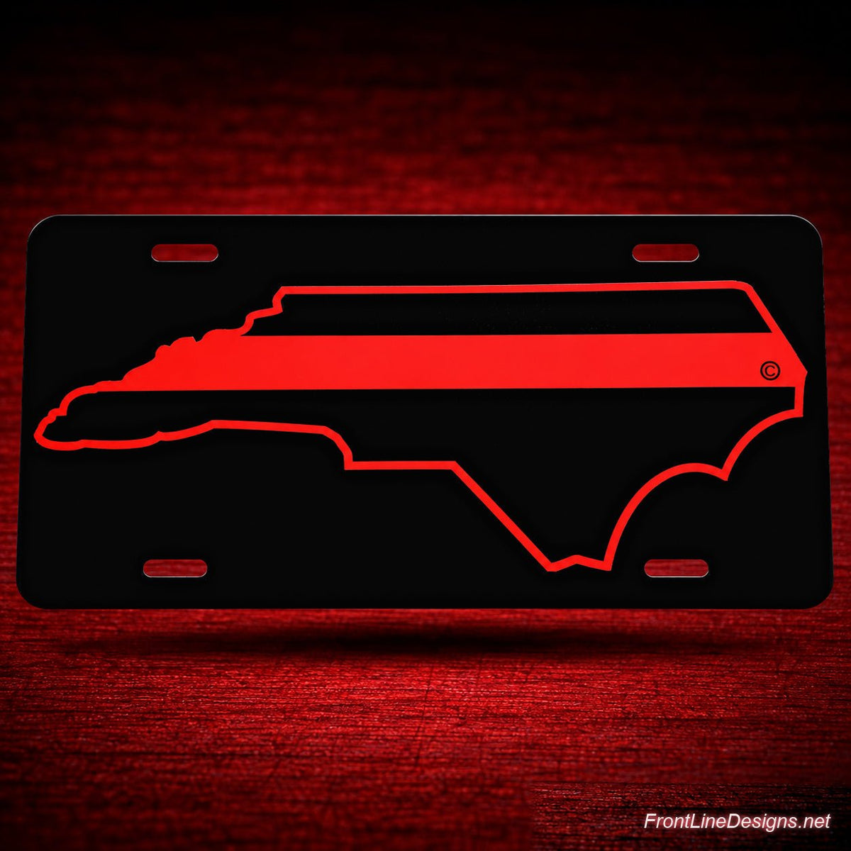 North Carolina Red Line Reflective License Plate — floating presentation on red textured backdrop